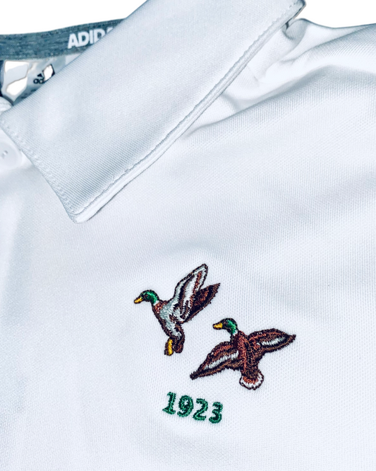 Adidas Kids Boys Three Stripe Golf Polo Shirt , close up of embroidered logo at the chest